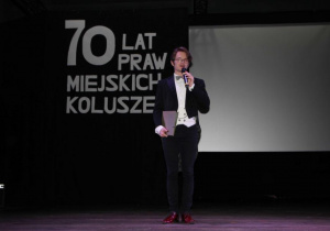 Zdjęcie konferansjera na scenie podczas obchodów 70-lecia Nadania Praw Miejskich Koluszkom w Miejskim Ośrodku Kultury w Koluszkach